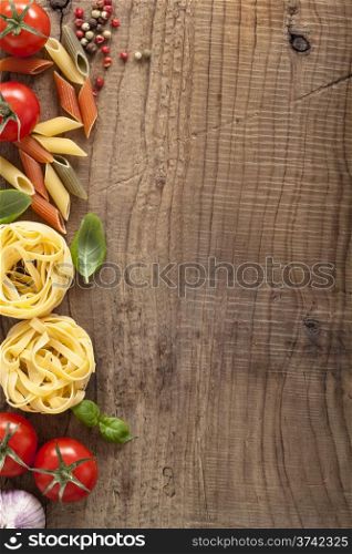 pasta tomatoes basil frame on wooden background