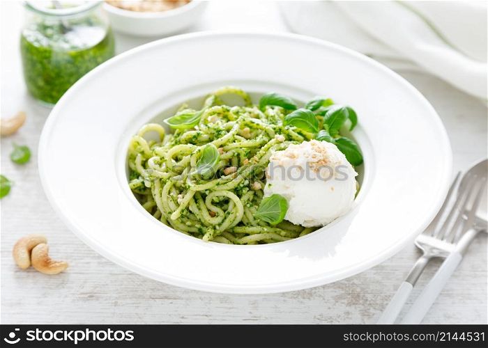 Pasta with basil pesto, cashew nuts and soft cream cheese