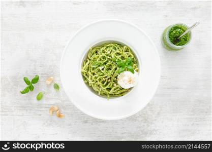 Pasta with basil pesto, cashew nuts and soft cream cheese. Top view