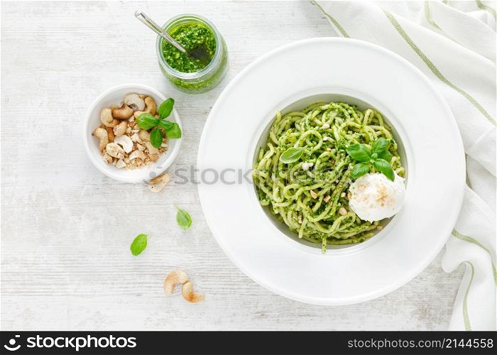 Pasta with basil pesto, cashew nuts and soft cream cheese. Top view