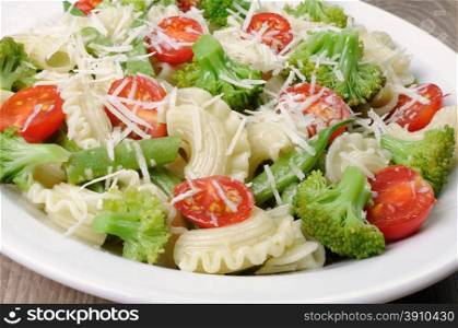 Pasta with broccoli, tomatoes, green beans and parmesan
