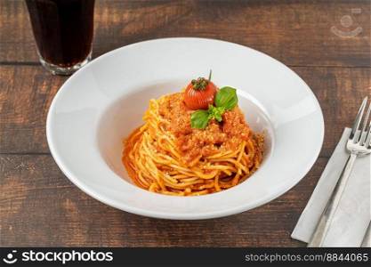 Pasta with cheese and tomato sauce on a white porcelain plate