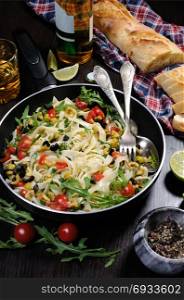 Pasta with crushed olives and cherry tomatoes, arugula.