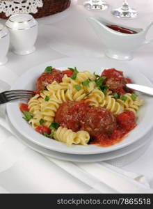 Pasta with meatballs in tomato sauce and herbs