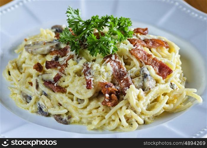 Pasta with sausage cheese and greens on the table&#xA;