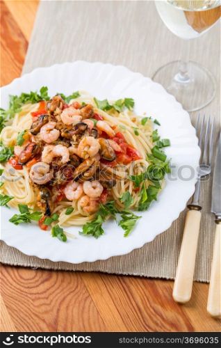 pasta with seafoods and white wine on napkins
