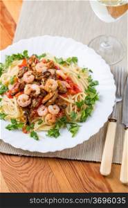 pasta with seafoods and white wine on napkins