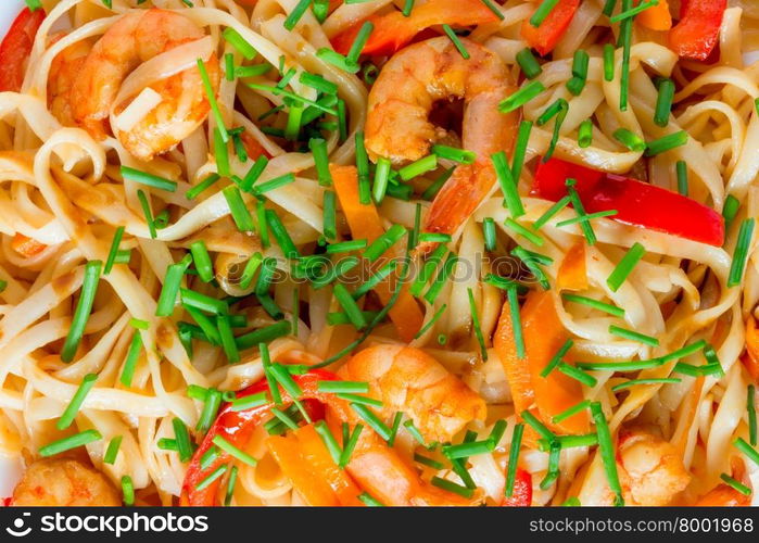 pasta with shrimp and vegetables in soy sauce closeup