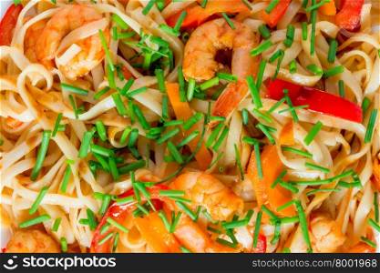 pasta with shrimp and vegetables in soy sauce closeup