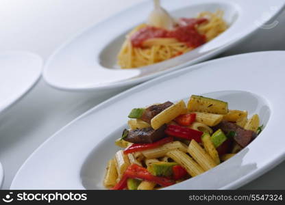 Pasta with shrimps, herbs and mashrooms isolated on white background in studio