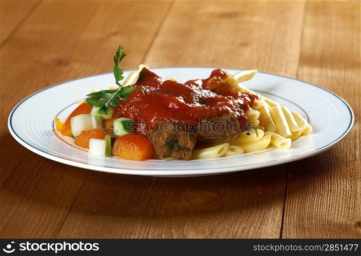 pasta with tomato beef sauce on wooden table