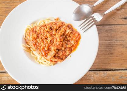 Pasta with tomato sauce on wooden table, stock photo