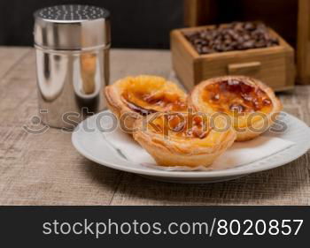 Pasteis de Nata or Portuguese Custard Tarts on wooden table.