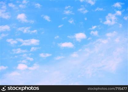 Pastel blue sky with white clouds - natural background with space for your own text
