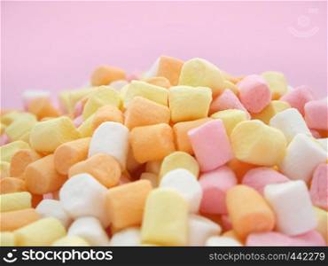 Pastel colored marshmallow on pink background.