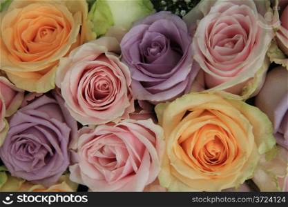 Pastel colored roses in a wedding flower arrangement