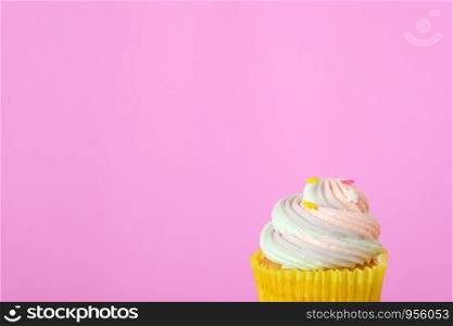 Pastel cupcake on pink background with copy space for text, birthday, anniversary greeting card background