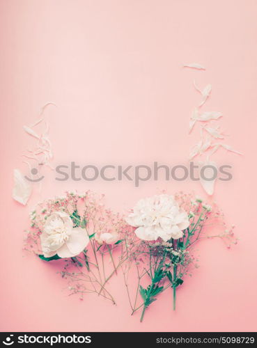 Pastel flowers frame with peony and petals on pink background, top view