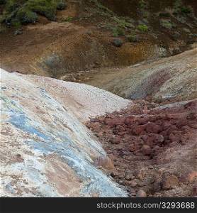 Pastel mineral deposits and grassy landscape