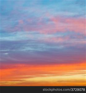 pastel pink and yellow sunrise clouds under blue morning sky in autumn
