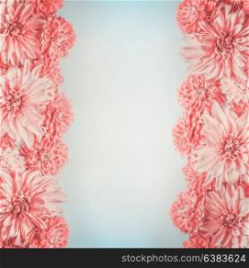 Pastel pink flowers frame on pale blue background, top view. Floral layout or mock up , vertical