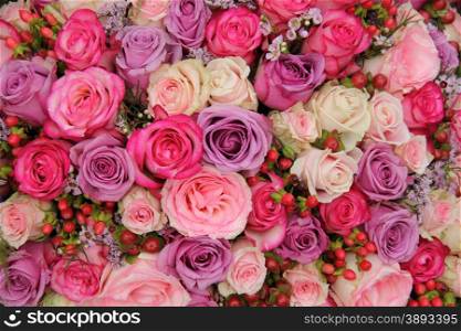 Pastel roses wedding arrangement in purple and pink