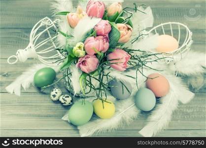 pastel tulip flowers and easter eggs. retro style colored picture. selective focus