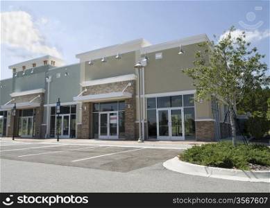 pastel, upscale strip mall with stone accents and large glass windows