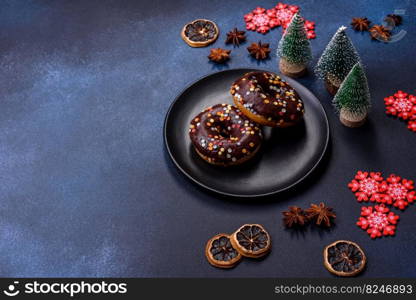 Pastries concept. Donuts with chocolate glaze with sprinkles, on a dark concrete table. Sweet food for a breakfast. Pastries concept. Donuts with chocolate glaze with sprinkles, on a dark concrete table