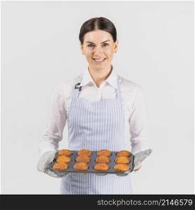 pastry chef female smiling with muffin tin