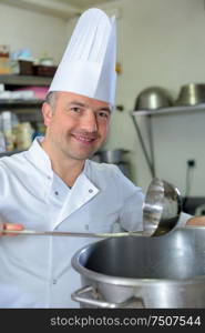 pastry chef holding delicious looking cakes and pastries