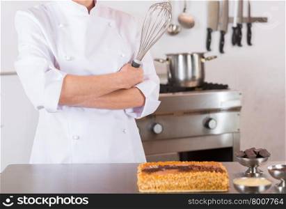Pastry chef presenting a yolk and cream cake
