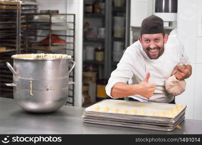 Pastry Chef with confectionary bag squeezing cream at pastry shop .. Pastry Chef with confectionary bag squeezing cream at pastry shop.