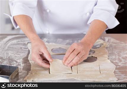 Pastry kneading a dough of a cake