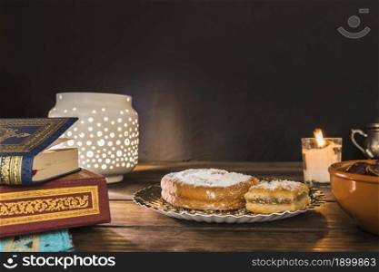pastry near books lantern. Resolution and high quality beautiful photo. pastry near books lantern. High quality beautiful photo concept