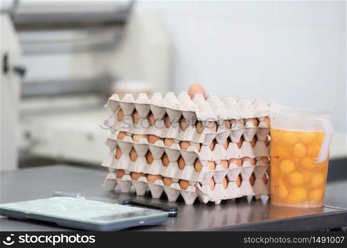 Pastry shop kitchen background, eggs, yolks, weight scale and laminator machine .. Pastry shop kitchen background, eggs, yolks, weight scale and laminator machine.