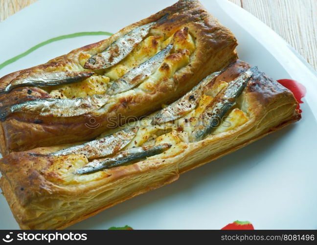 Pastry tart with anchovies. French cuisine