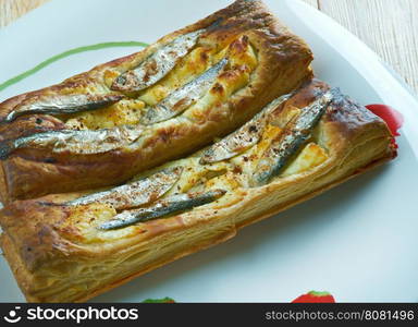 Pastry tart with anchovies. French cuisine