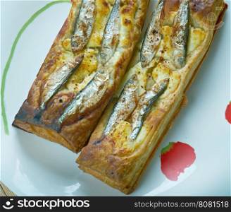 Pastry tart with anchovies. French cuisine