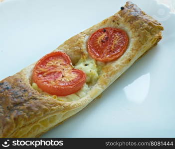 Pastry tart with cheese and tomatoes. close up