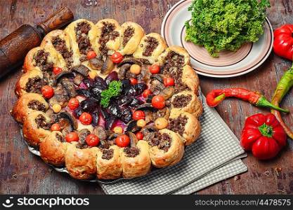 Pasty stuffed with meat. Traditional pie stuffed with meat decorated vegetables