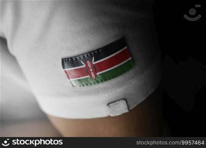 Patch of the national flag of the Kenya on a white t-shirt.. Patch of the national flag of the Kenya on a white t-shirt