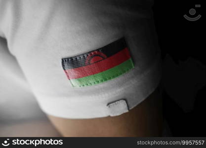 Patch of the national flag of the Malawi on a white t-shirt.. Patch of the national flag of the Malawi on a white t-shirt