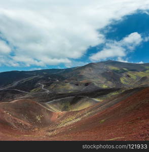 Path between summer Etna volcano mountain craters, Sicily, Italy. People unrecognizable.