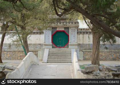 Pathway Leading To A Traditional Chinese Door Separating Areas Of The Summer Palace In Beijing