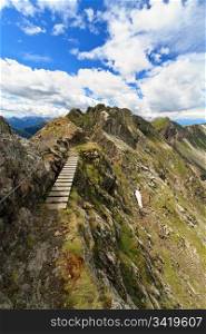pathway with footbridge on Monzoni ridge, Italian Dolomites