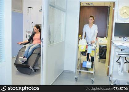 patient and nurse on trolleys in hospital