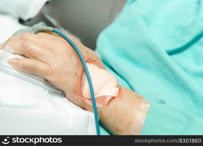 Patient asian elder woman 80s flu covid19 with pulse gauge for heartbeat measuring and blood pressure on a patient elderly finger on patient bed in intensive care unit (ICU.) room at hospital. Patient in the hospital with pulse gauge on finger