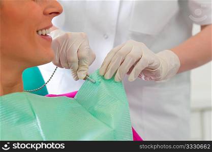 Patient at the beginning of a treatment ? Assistant is putting the protection on