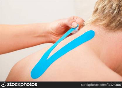 Patient at the physiotherapy with different tapes